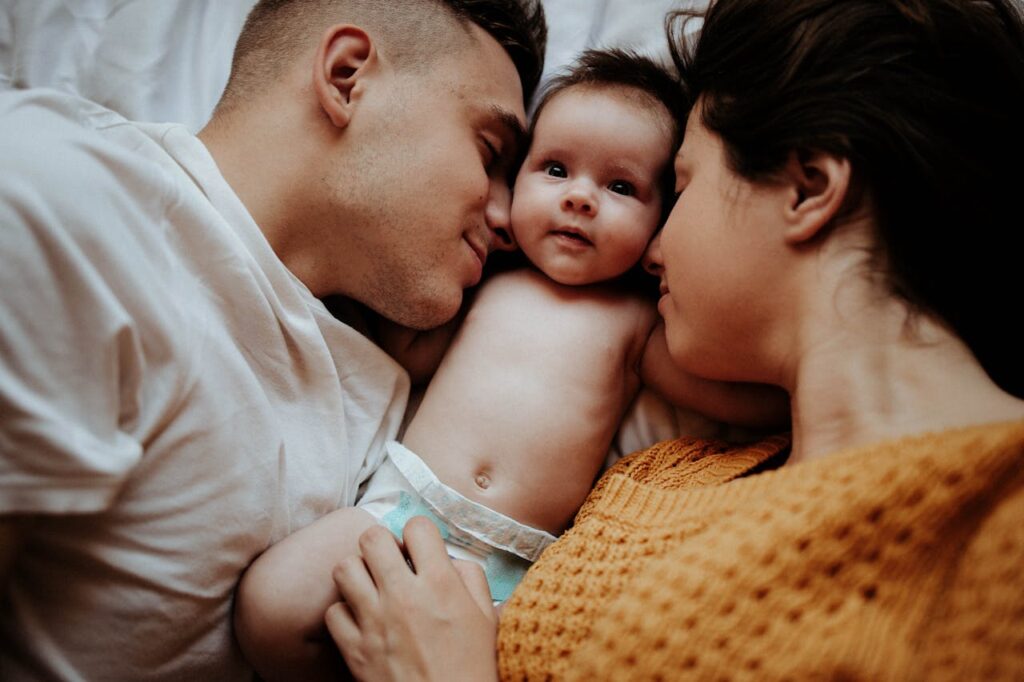 Mother feeding baby with a milk bottle, demonstrating proper bottle-feeding technique and the use of an anti-colic teat for comfort.